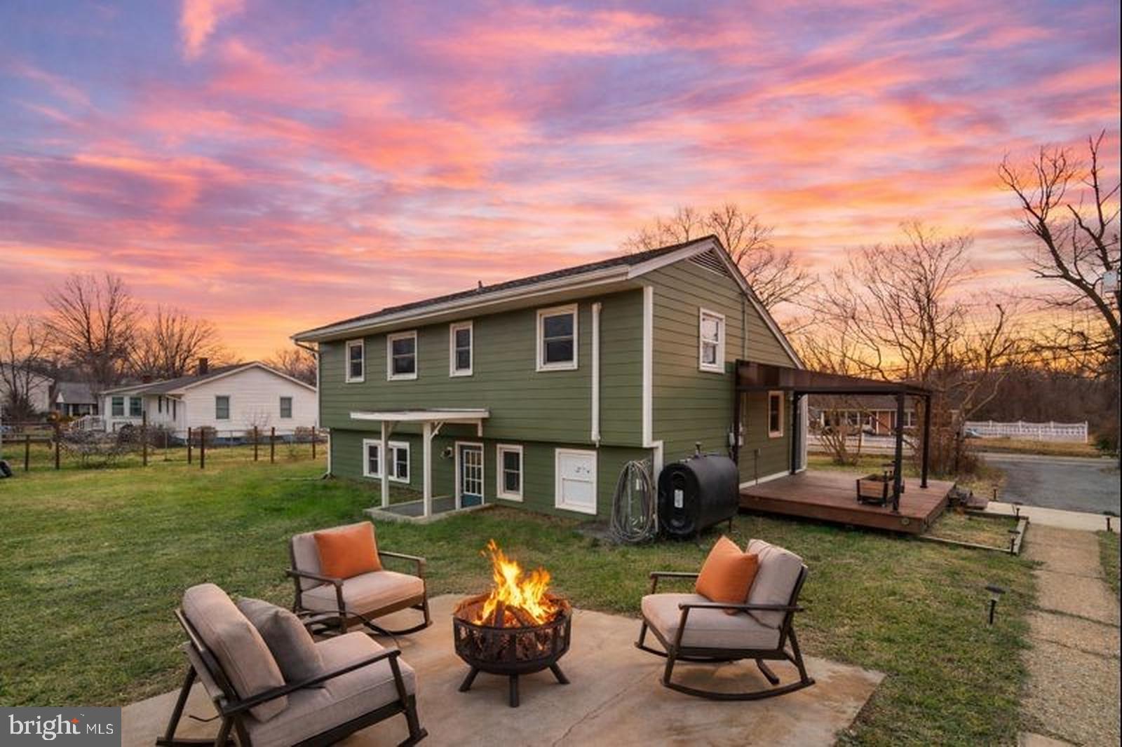 a front view of a house with patio furniture and garden