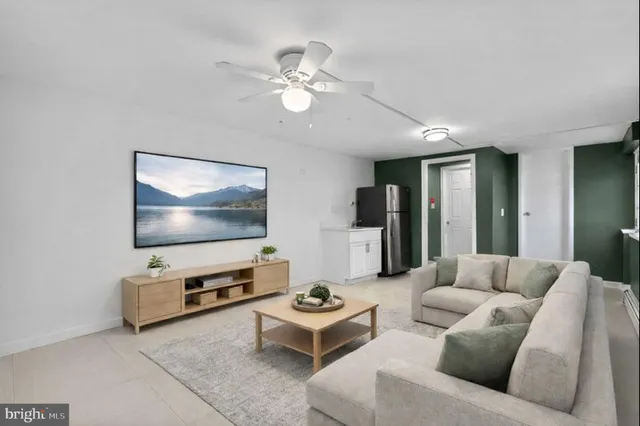 a living room with furniture and a flat screen tv