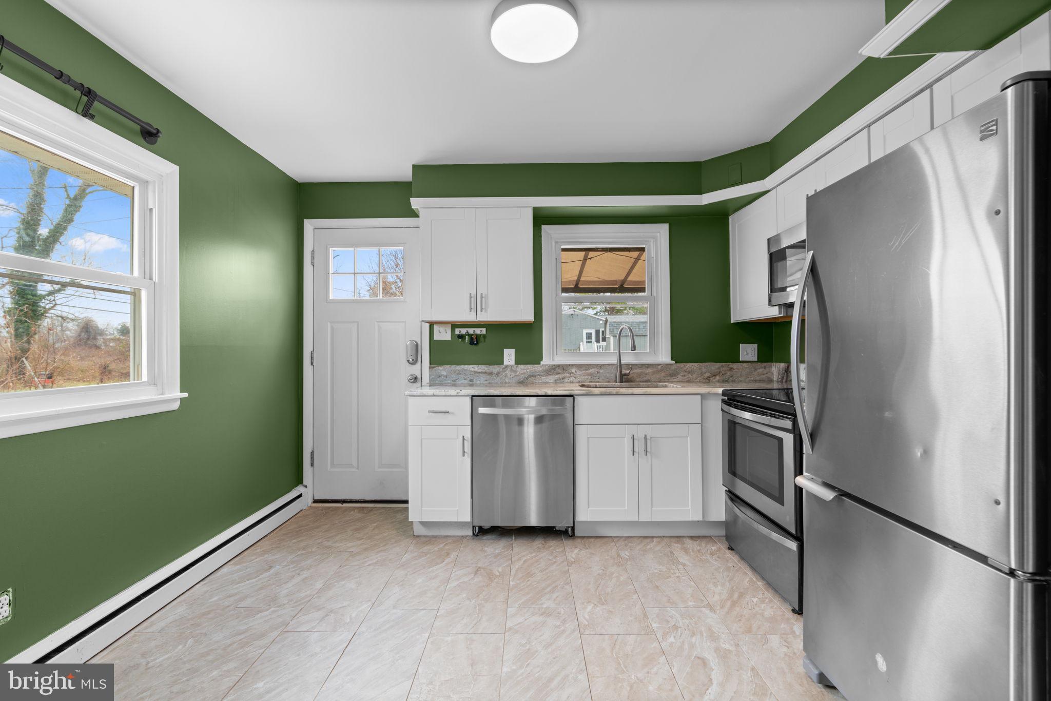 226 Maryland Way Edgewater, MD 21037 - Photo 12 of 30 a kitchen with a refrigerator and a stove