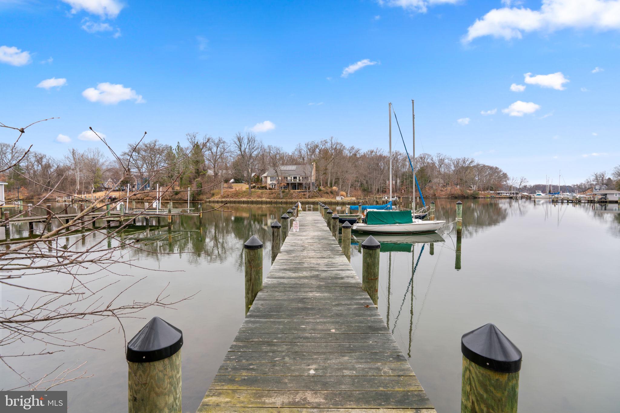 226 Maryland Way Edgewater, MD 21037 - Photo 20 of 30 a view of a lake with boats and trees in the background