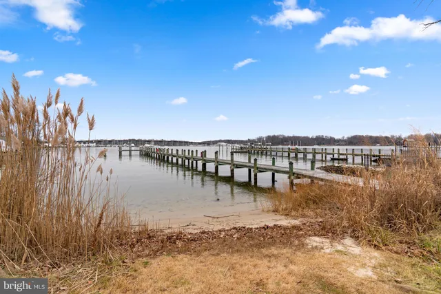 a view of a lake with table and chairs