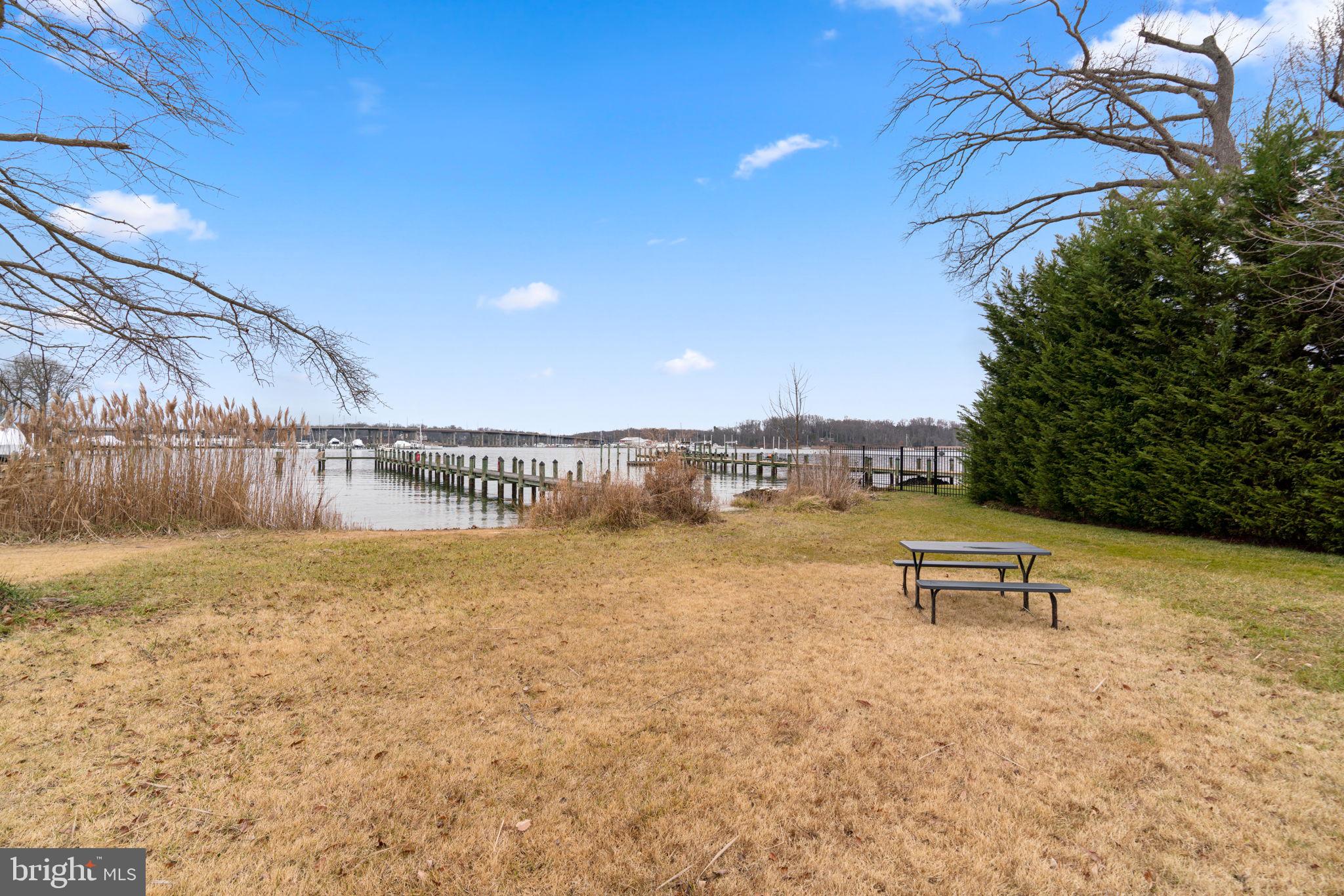 226 Maryland Way Edgewater, MD 21037 - Photo 24 of 30 a view of a lake with a bench in the background