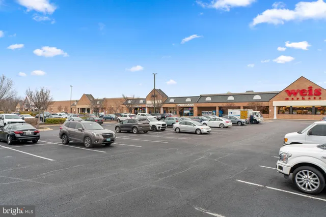 a view of a cars park in front of a building
