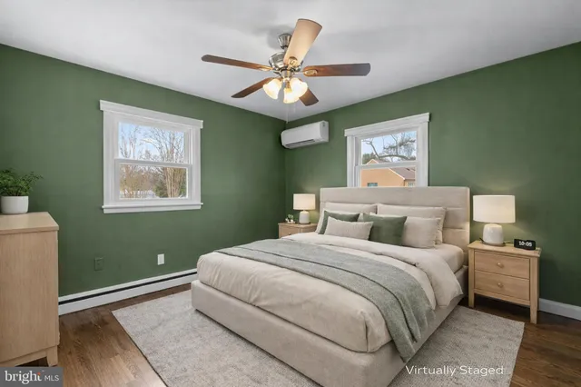 a bedroom with a large bed and a chandelier