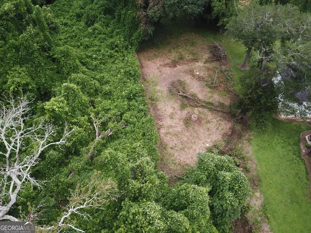 an aerial view of a house with a yard