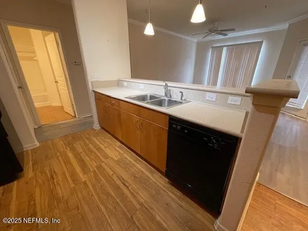 a view of a room with wooden floor and a window