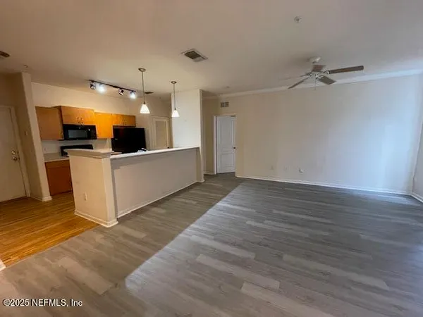 a view of a kitchen with wooden floor and a sink