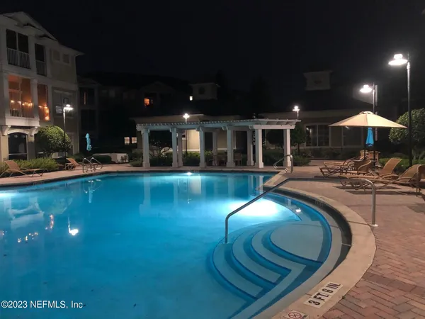 a view of a swimming pool with an outdoor seating