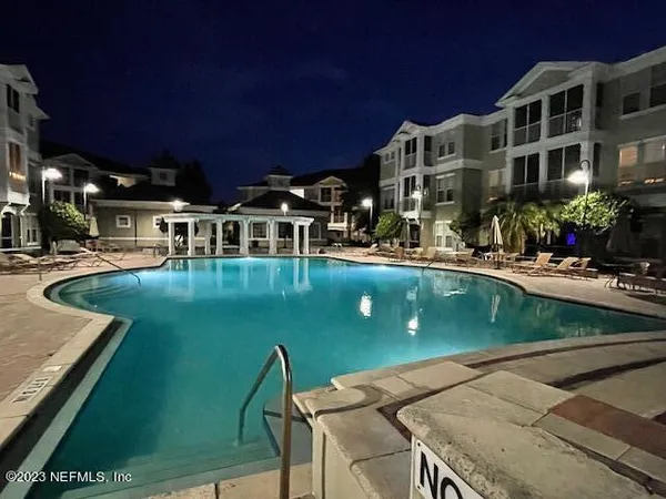a view of a swimming pool with chairs