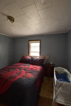 a bedroom with a bed and window