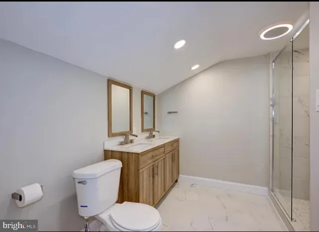 a bathroom with a toilet a sink and mirror