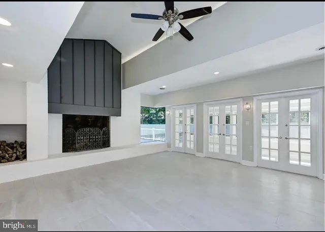 a view of an empty room with a fireplace and a window