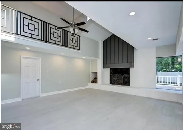 a view of an empty room with a fireplace