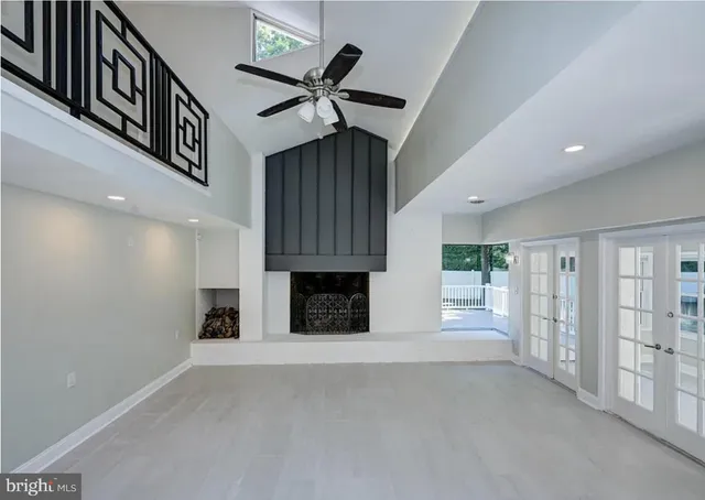 a view of empty room with fireplace and stairs