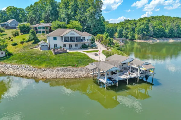 a view of a lake with a house swimming pool and outdoor space
