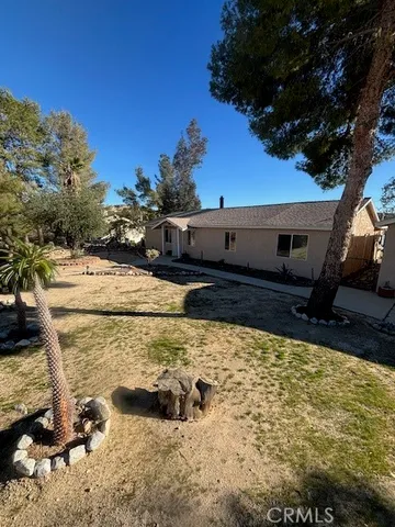 a view of a backyard of the house