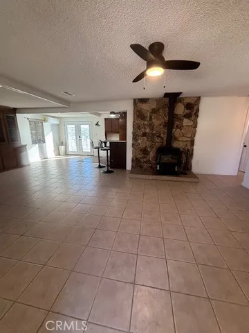 a view of a livingroom with furniture and chandelier fan