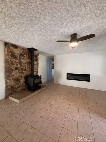 a view of a livingroom with furniture and a chandelier fan