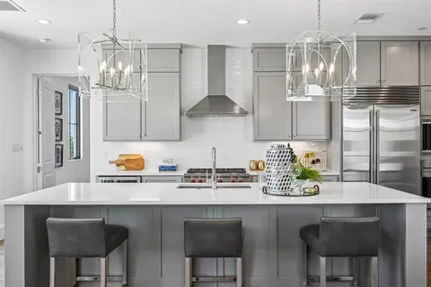 a kitchen with stainless steel appliances a sink and cabinets