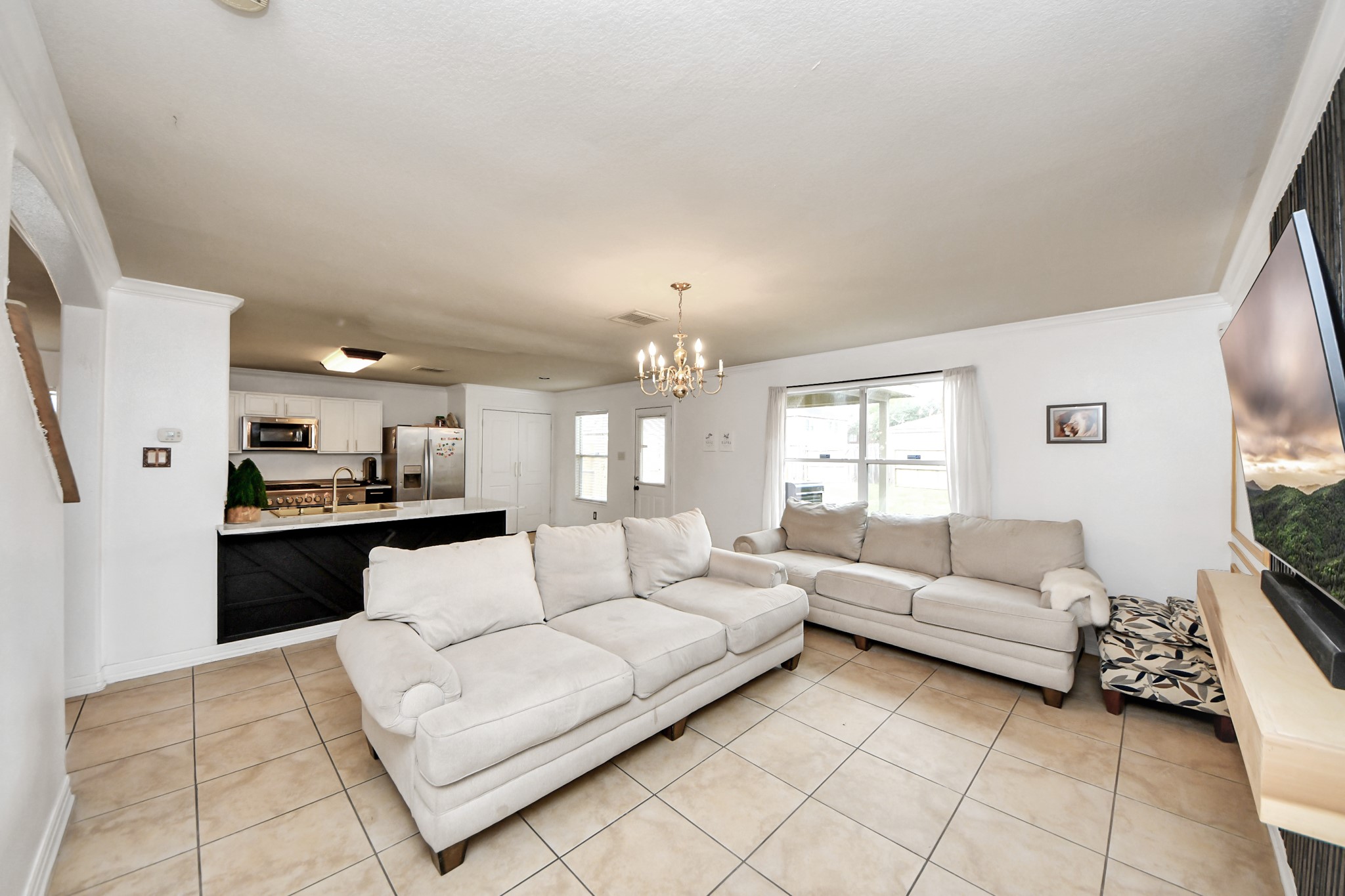611 Remwick Drive Houston, TX 77073 - Photo 15 of 42 a living room with furniture and a chandelier