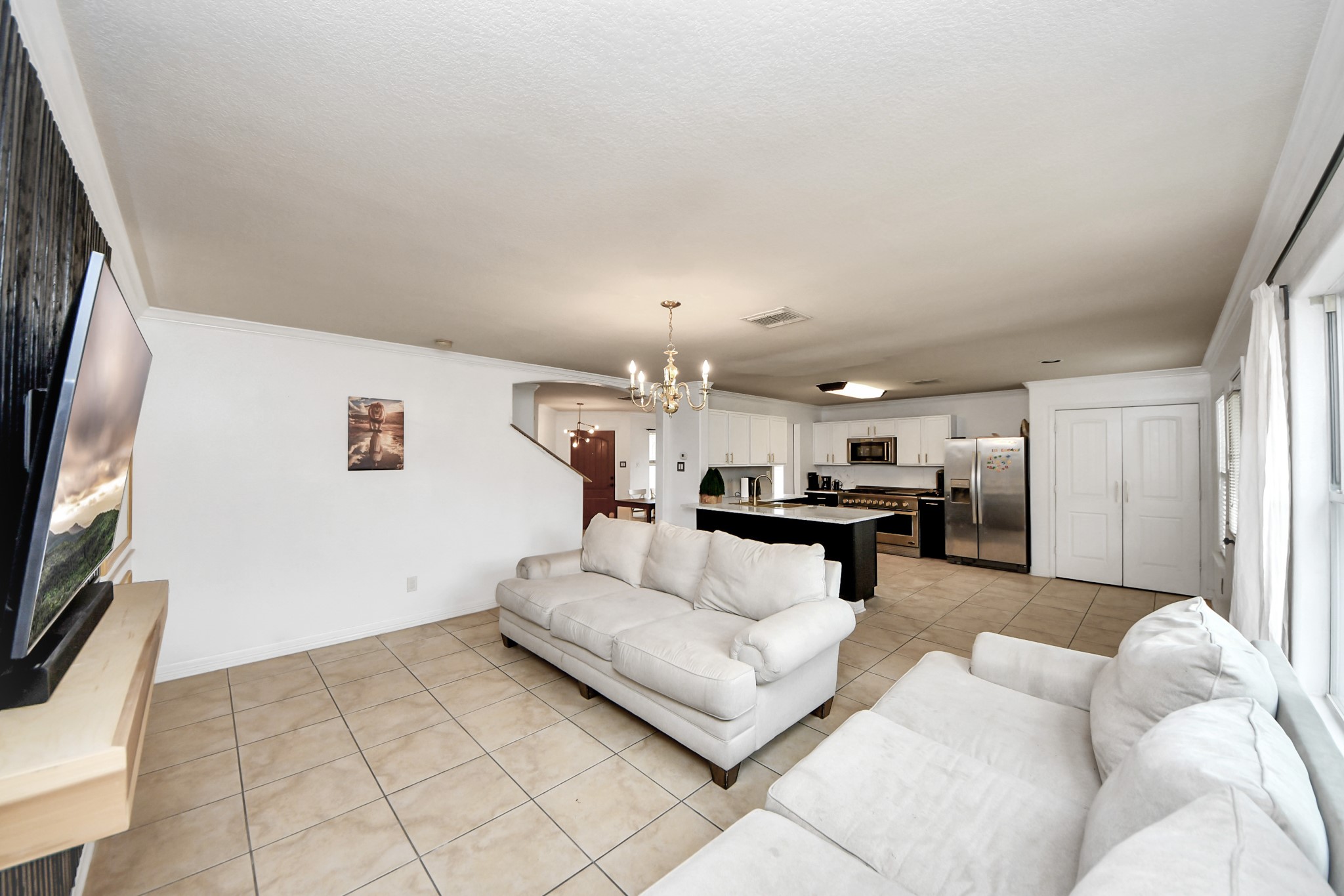 611 Remwick Drive Houston, TX 77073 - Photo 16 of 42 a living room with furniture and a flat screen tv