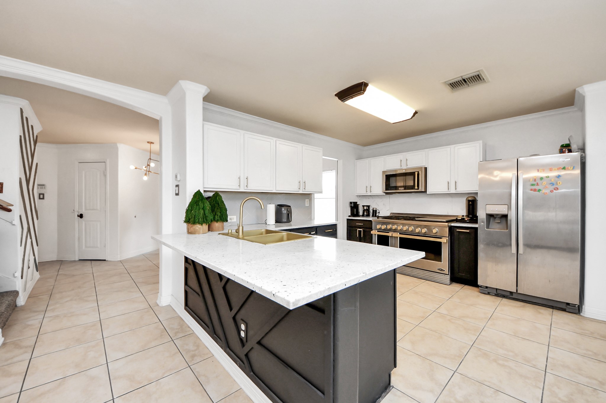 611 Remwick Drive Houston, TX 77073 - Photo 17 of 42 a kitchen with a sink refrigerator and microwave
