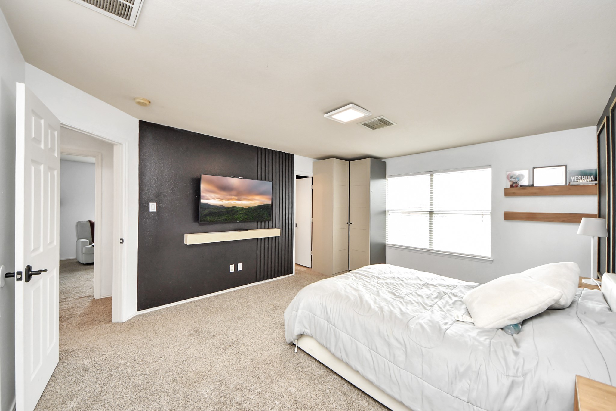 611 Remwick Drive Houston, TX 77073 - Photo 24 of 42 a bedroom with a bed and a flat screen tv