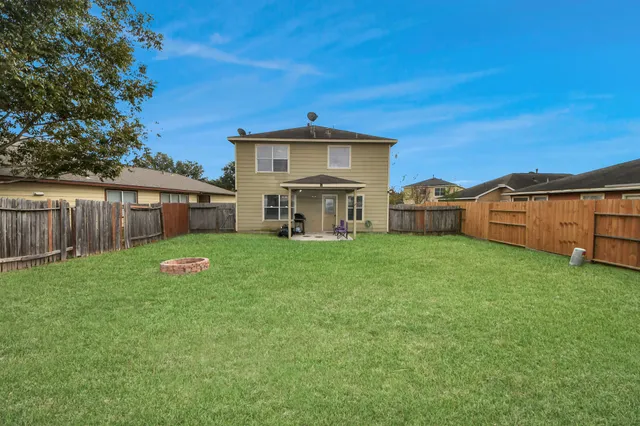 a view of a house with a yard and sitting area