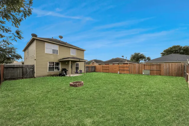 a view of house with backyard