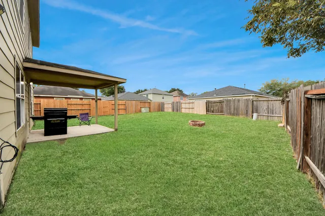 a view of a patio with table and chairs potted plants with wooden fence