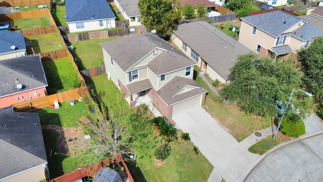 an aerial view of residential houses with outdoor space