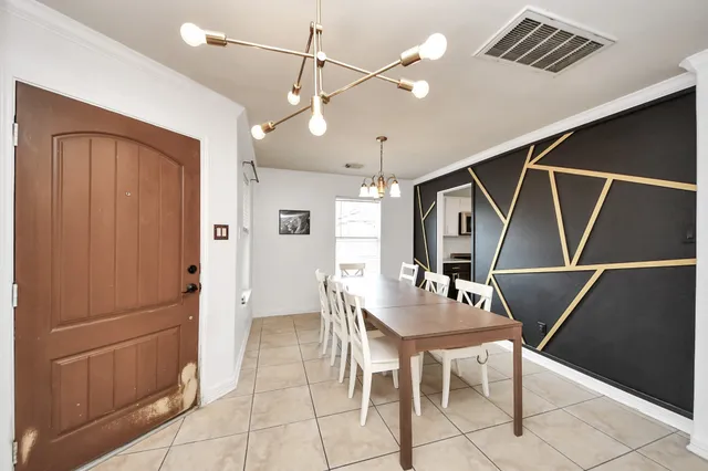 a dining room with furniture and window