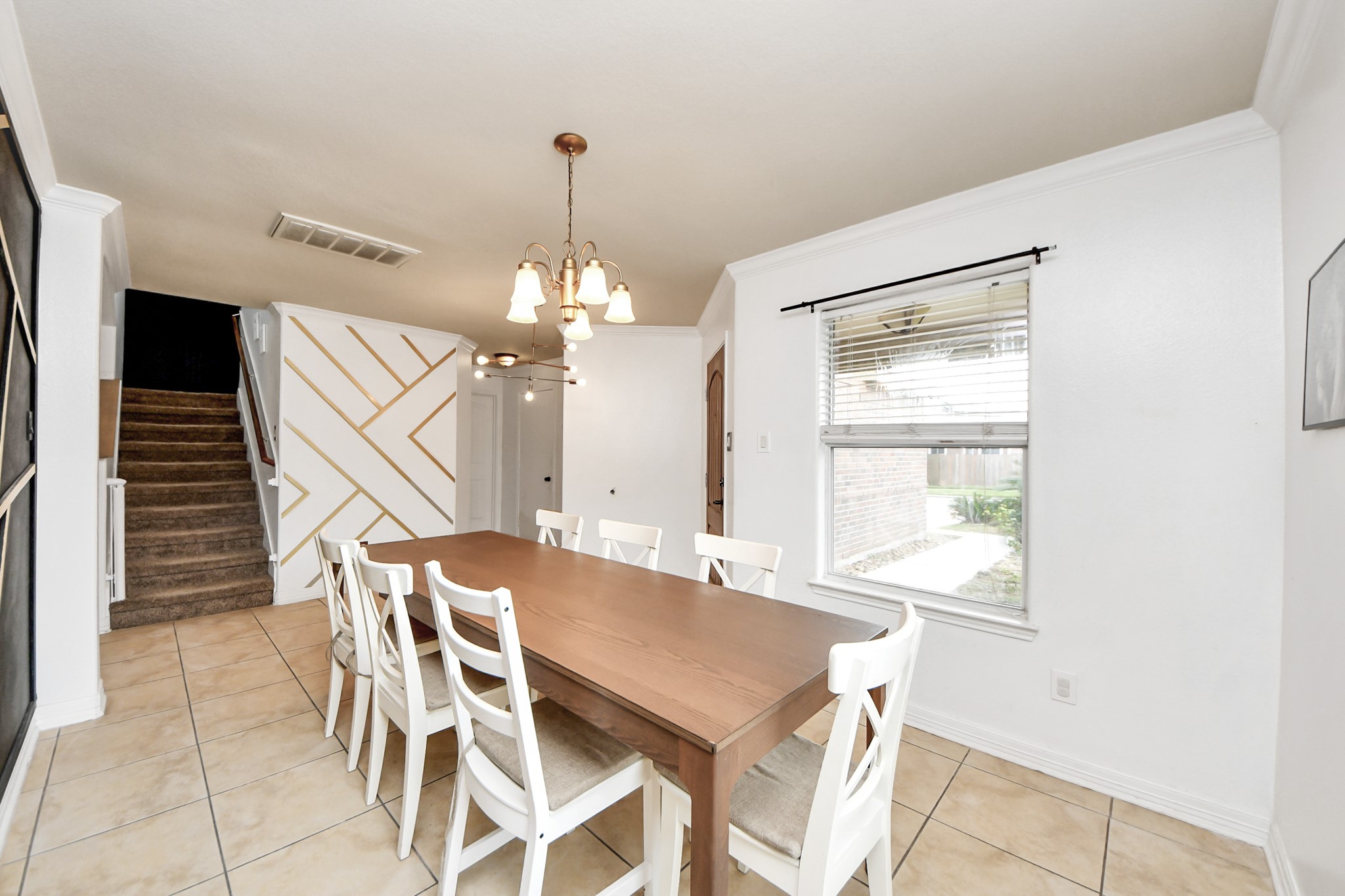 611 Remwick Drive Houston, TX 77073 - Photo 9 of 42 a view of a dining room with furniture and a chandelier
