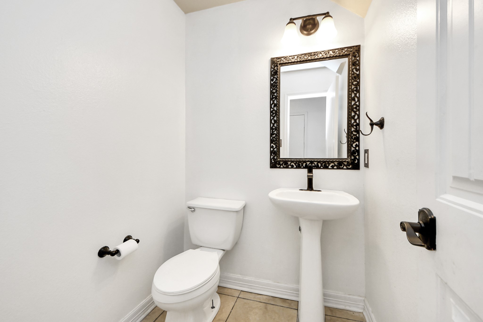 611 Remwick Drive Houston, TX 77073 - Photo 10 of 42 a bathroom with a toilet sink and mirror