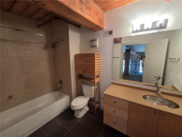 a bathroom with a sink a toilet and bathtub