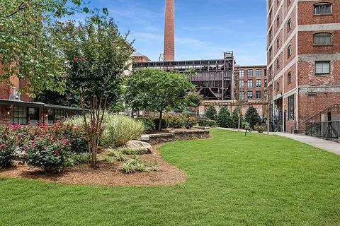 a view of a chair and table on the garden