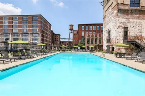 a swimming pool view with outdoor seating