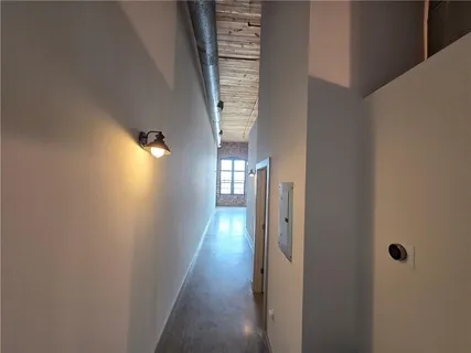 a view of a hallway with wooden floor and staircase