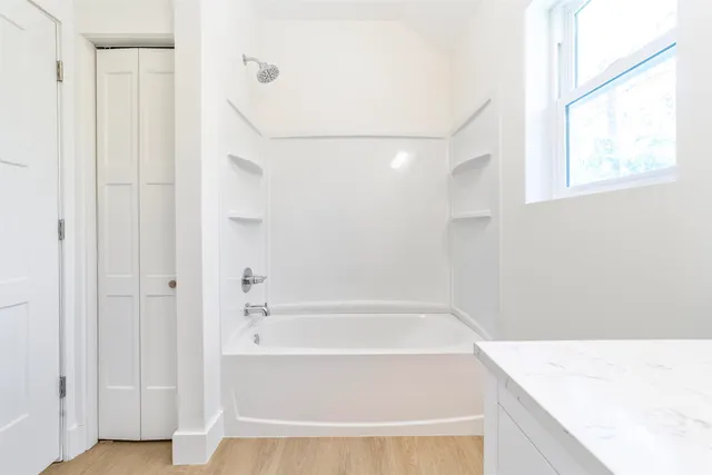 a bathroom with a bathtub and a shower