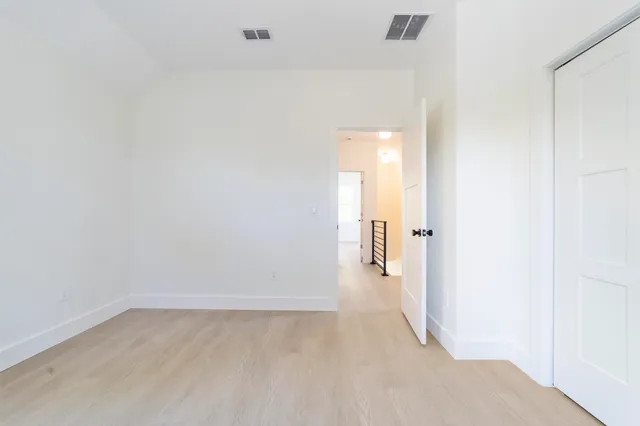 a view of a room with wooden floor