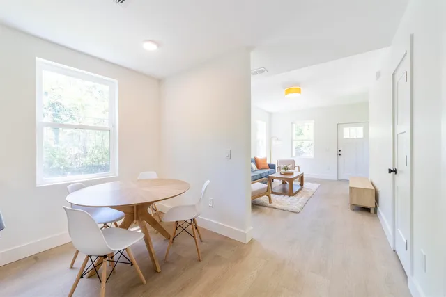 a dining room with furniture and wooden floor