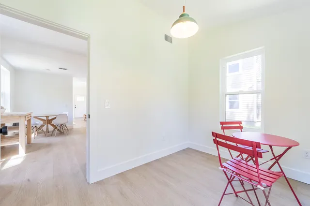 a dining room with furniture and wooden floor