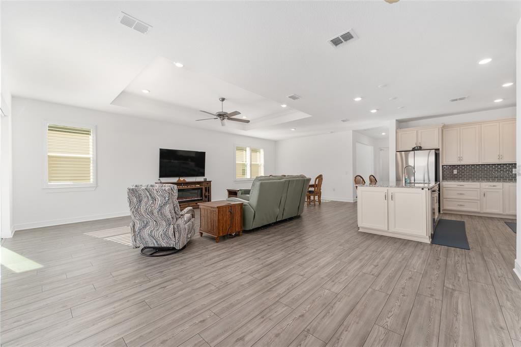 6034 Southwest 86th Circle Ocala, FL 34481 - Photo 11 of 59 a living room with furniture and a flat screen tv