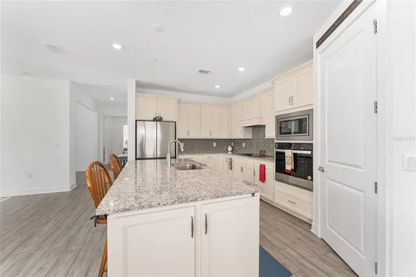 a kitchen with white cabinets and white appliances