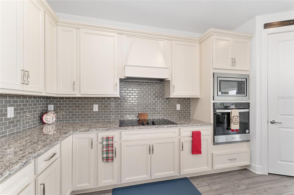 6034 Southwest 86th Circle Ocala, FL 34481 - Photo 17 of 59 a kitchen with white cabinets and white appliances