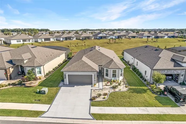 a view of a hallway with wooden floor and a window