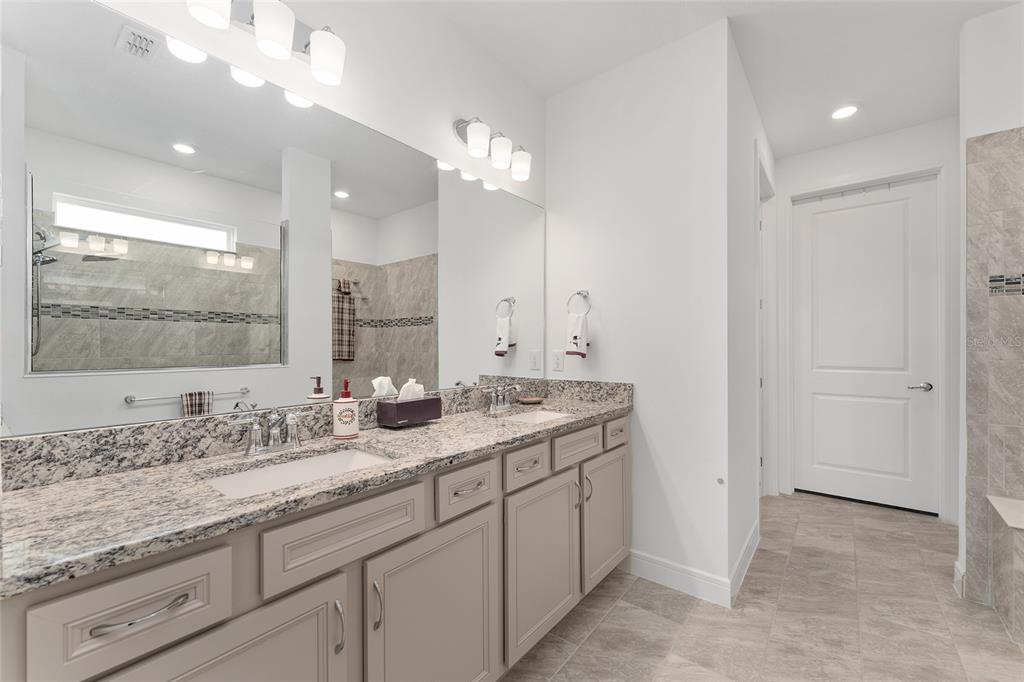 6034 Southwest 86th Circle Ocala, FL 34481 - Photo 23 of 59 a bathroom with a sink double vanity and a mirror