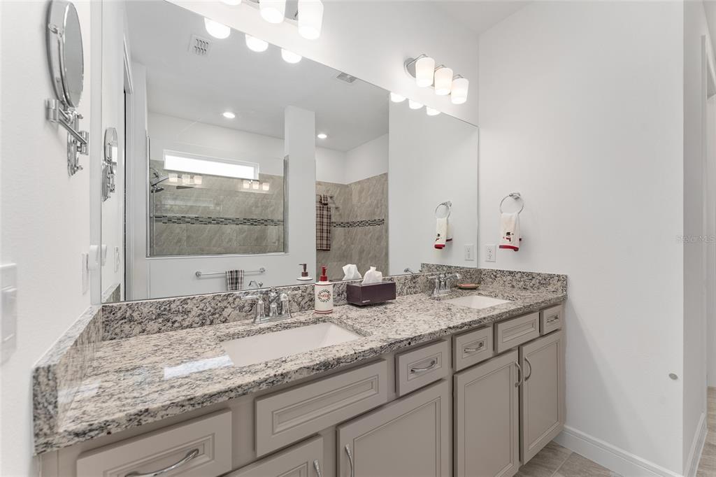 6034 Southwest 86th Circle Ocala, FL 34481 - Photo 24 of 59 a bathroom with a granite countertop double vanity sink and mirror