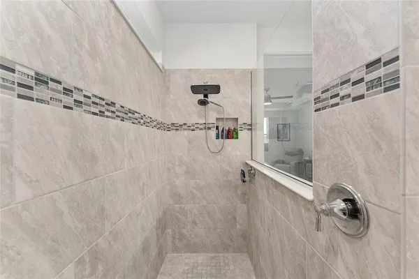 a bathroom with a granite countertop sink a toilet and shower