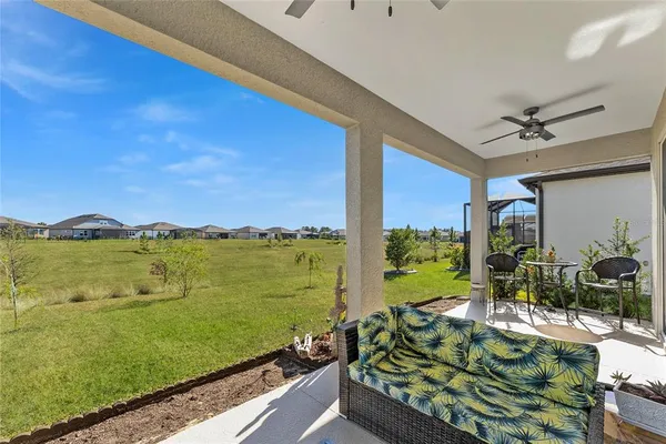 an aerial view of a house with swimming pool patio and outdoor seating